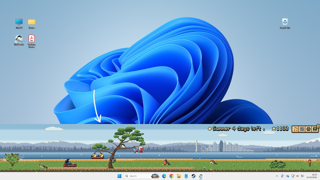 A Windows desktop with the Bird Feeder strip along the bottom, just above the taskbar, full of birds, trees and feeders.