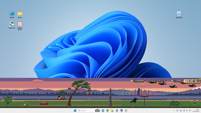 The same desktop at dusk: the strip glows in warm evening colours above the taskbar.